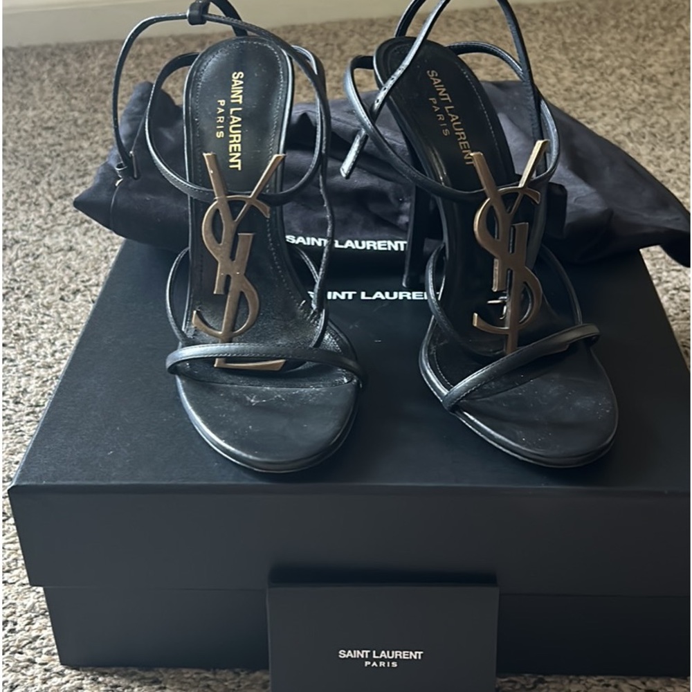 Cassandra, YSL medallion stiletto sandal
